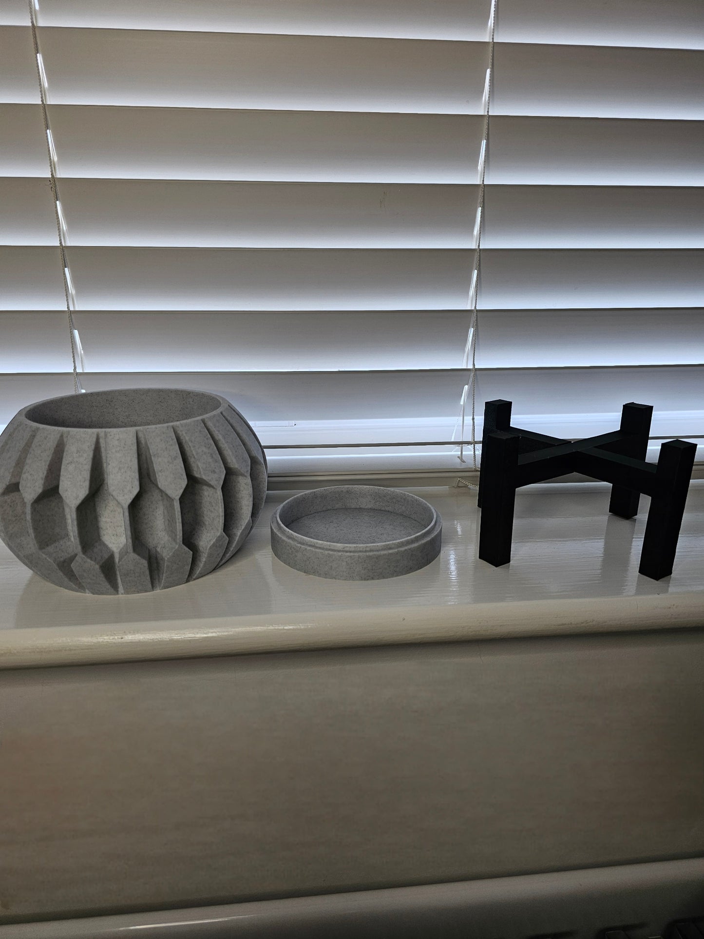 3D printed planter with raised detail, including drainage tray and black stand