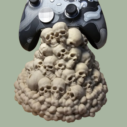 3D printed game controller holder with skull and teeth details in a bone colour