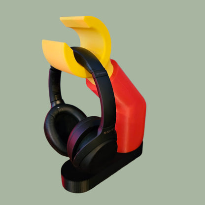 3D printed block style arm in various colours, with black base for wall or freestanding mounting, with chunky yellow hand to hold headphones or coats