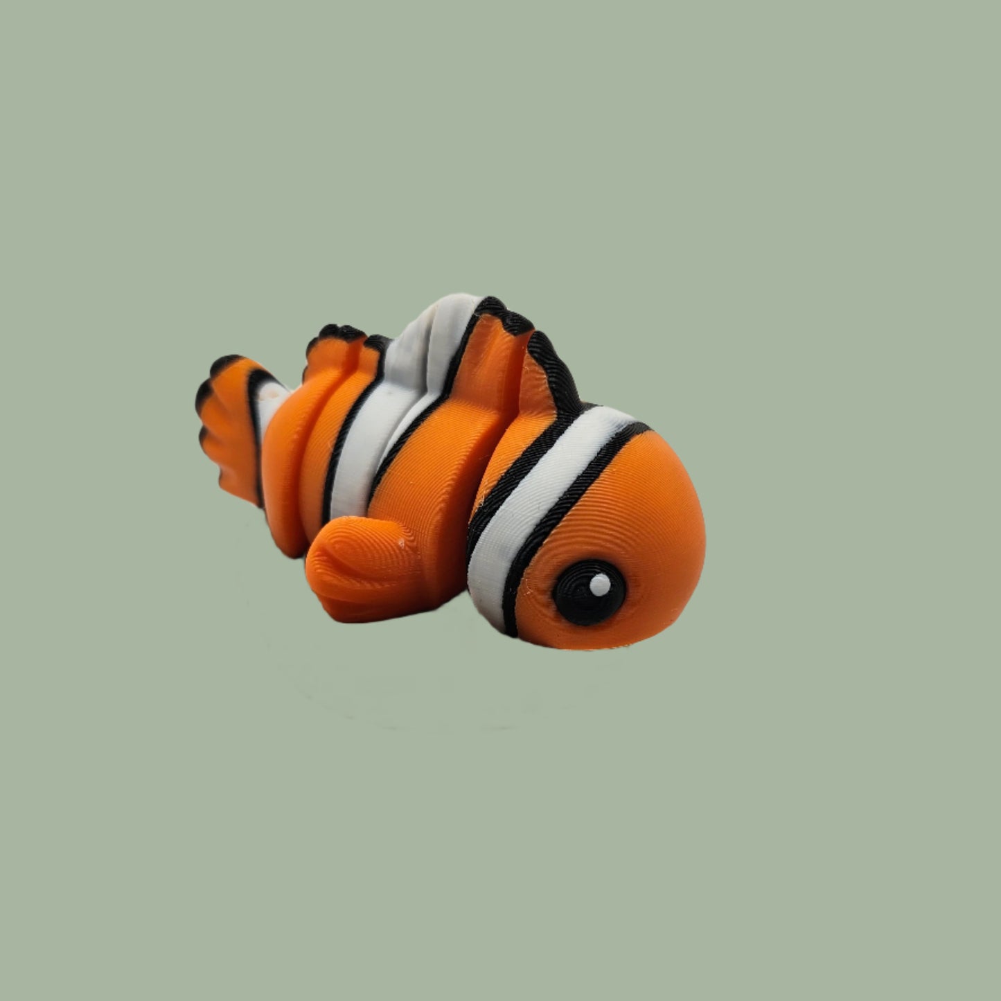 3D printed orange, white, and black clown fish articulated desk buddy