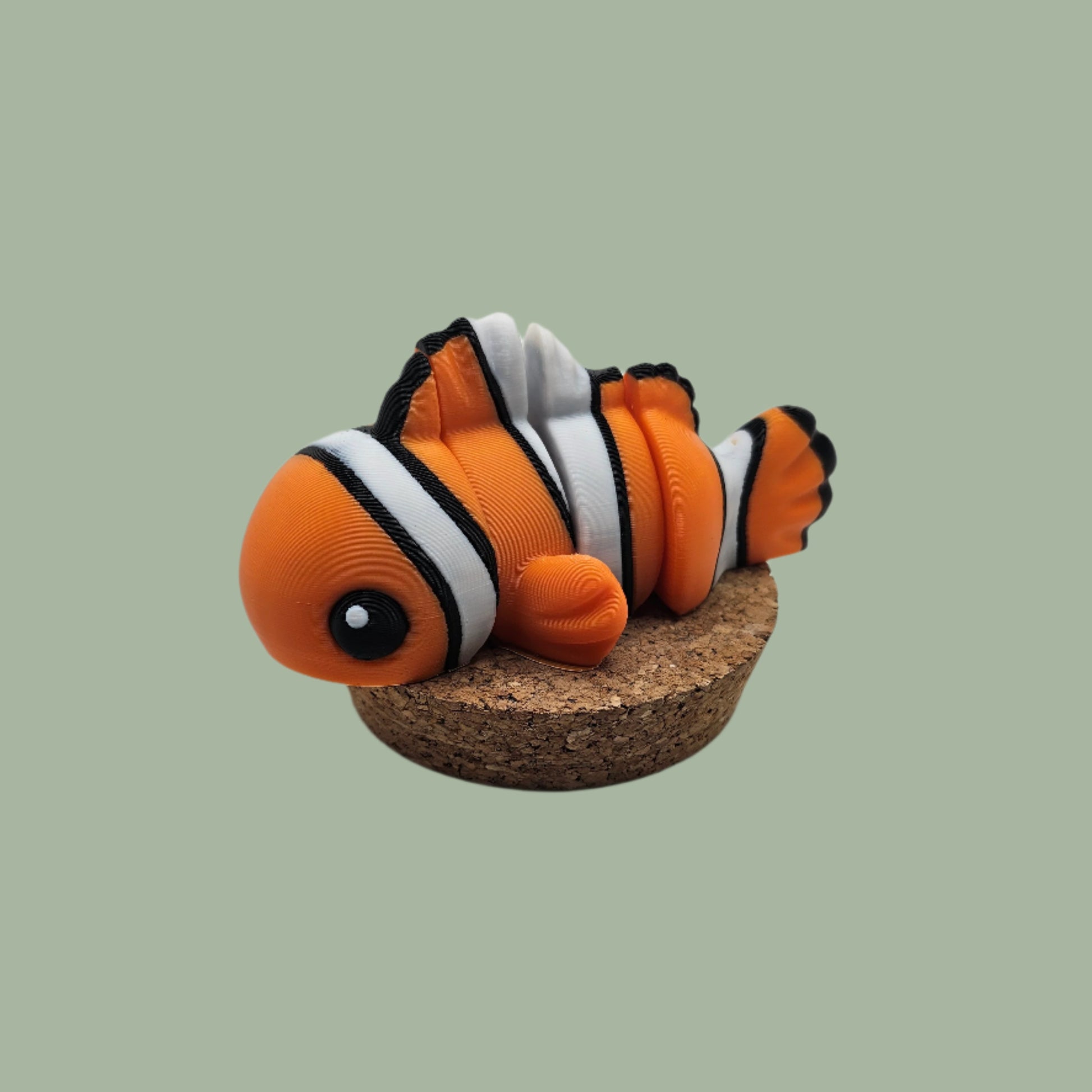 3D printed orange, white, and black clown fish articulated desk buddy