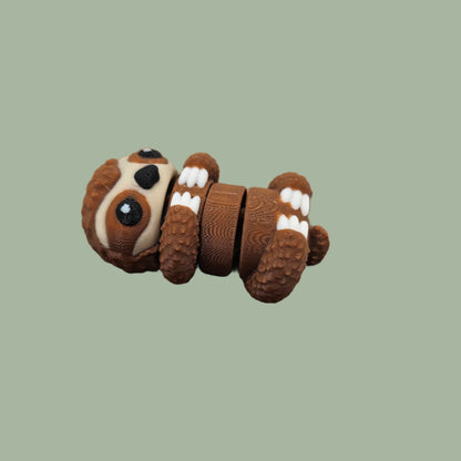 3D printed brown, white, and black sloth articulated fridge magnet