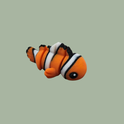 3D printed orange, white, and black clown fish articulated fridge magnet