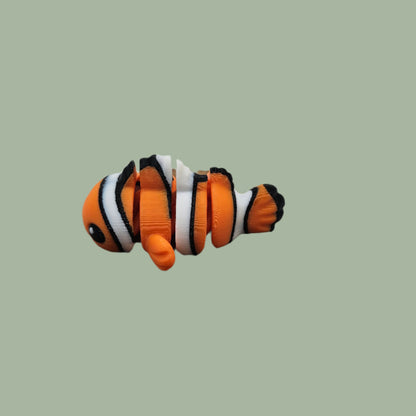 3D printed orange, white, and black clown fish articulated fridge magnet