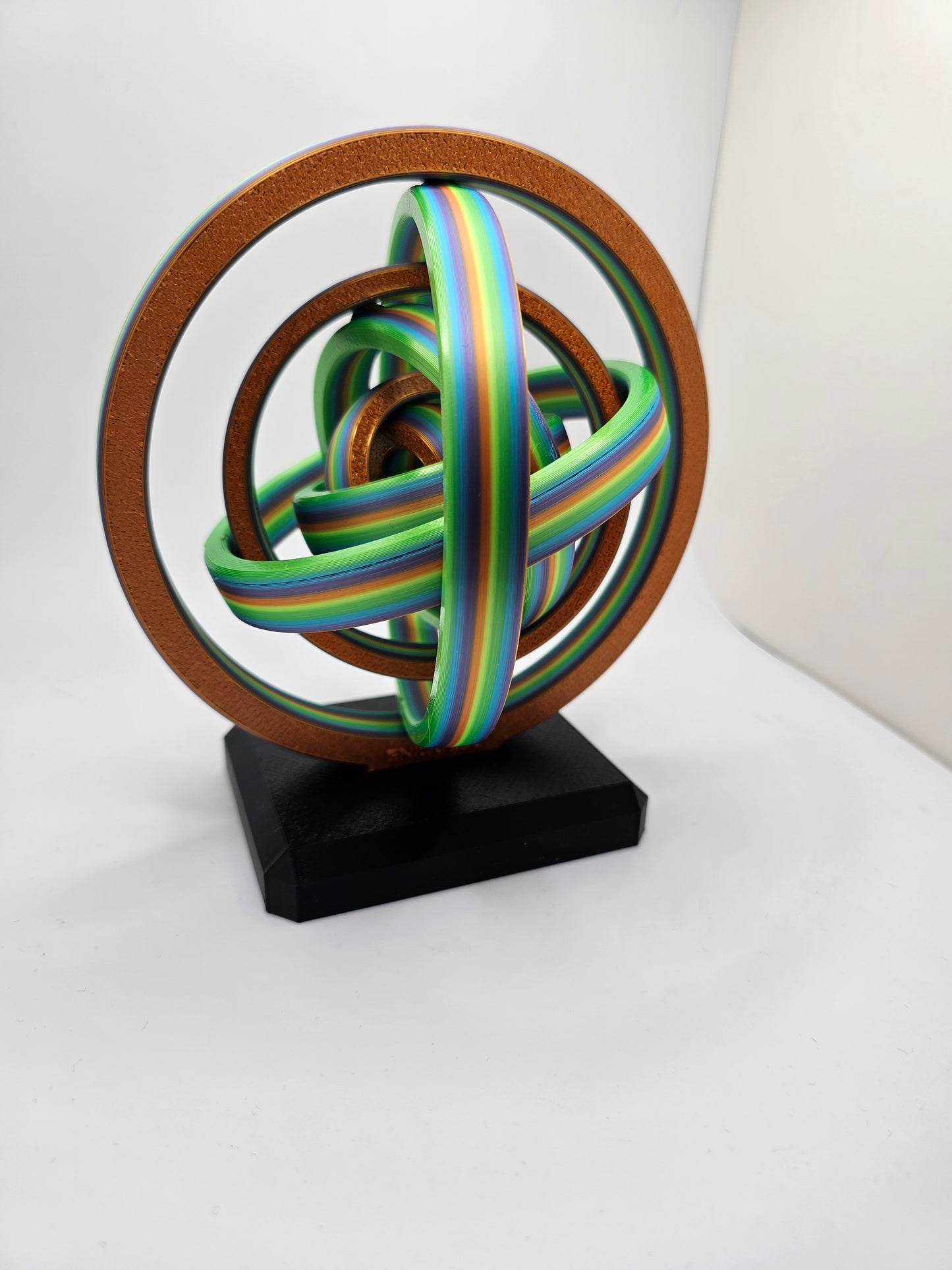 3D printed gyroscopic kinetic art on a black base