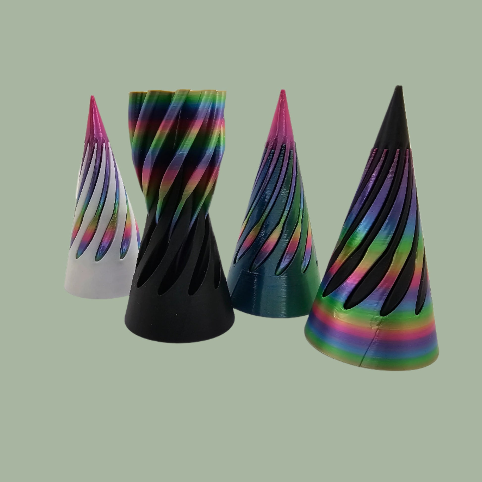 vibrant 3D-printed Infinity Cones V2, each featuring a sleek spiral cut design. The cones are in a random colour, including white, green, black, and rainbow gradients. Designed for smooth sliding and fidgeting, these eye-catching desk toys are handmade in the UK