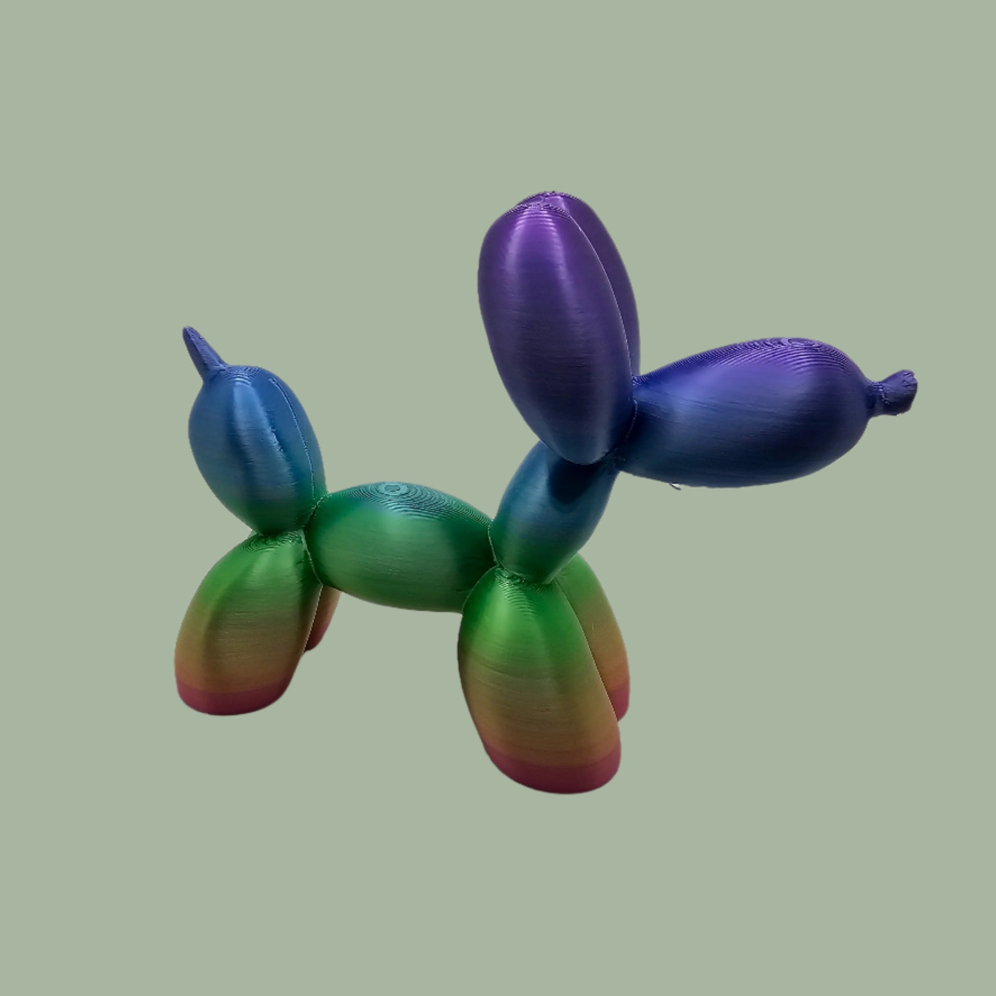 Unique rainbow balloon dog figurine, 3D printed with a smooth, glossy finish. A colourful and fun sculpture for home or office decor