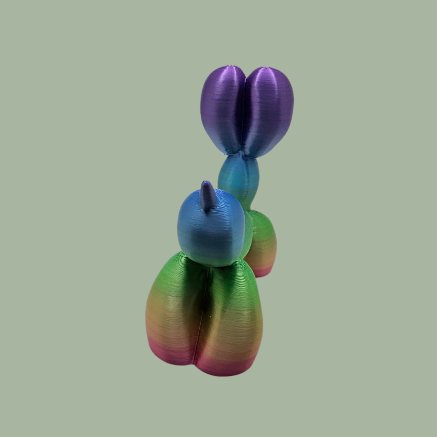 Unique rainbow balloon dog figurine, 3D printed with a smooth, glossy finish. A colourful and fun sculpture for home or office decor