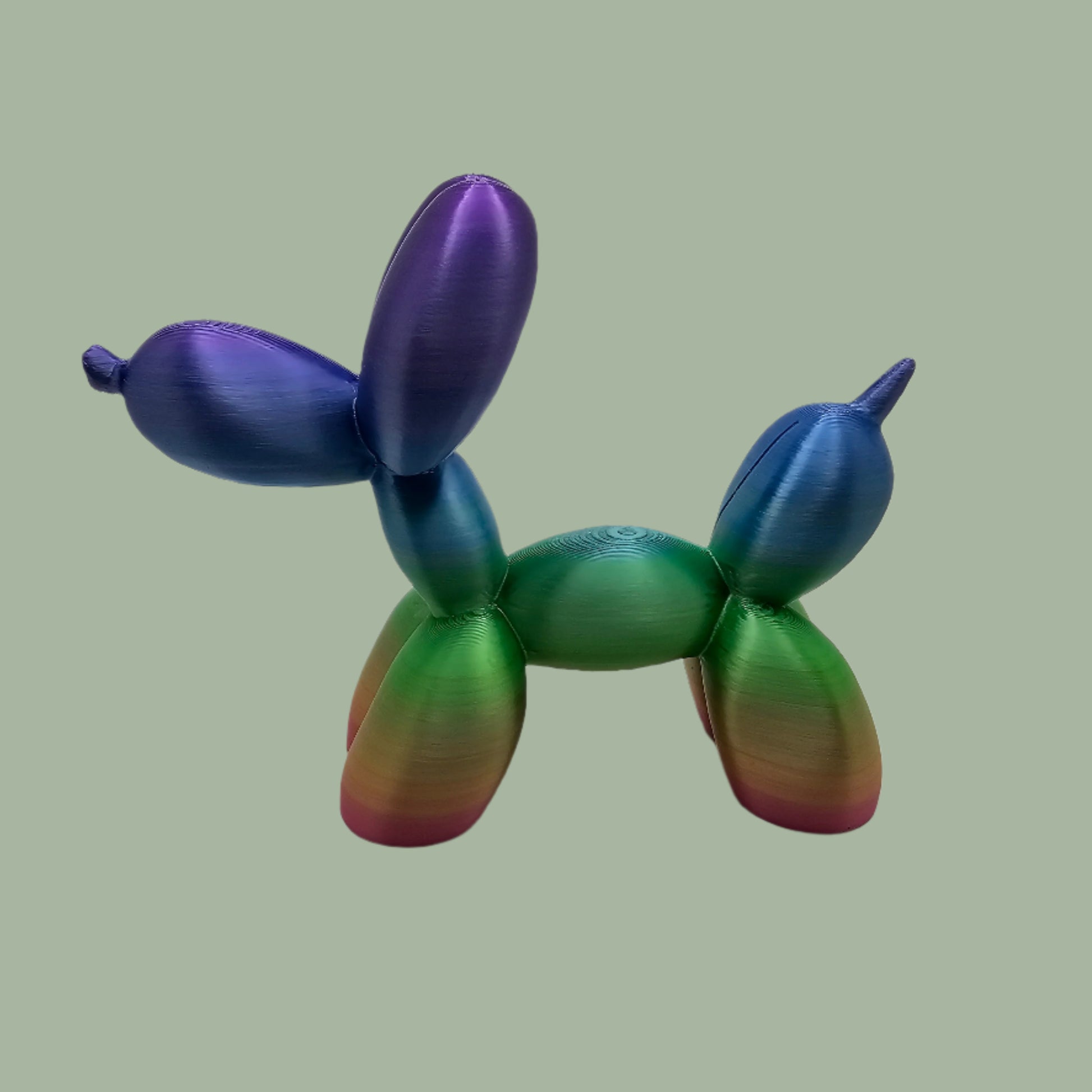 Unique rainbow balloon dog figurine, 3D printed with a smooth, glossy finish. A colourful and fun sculpture for home or office decor