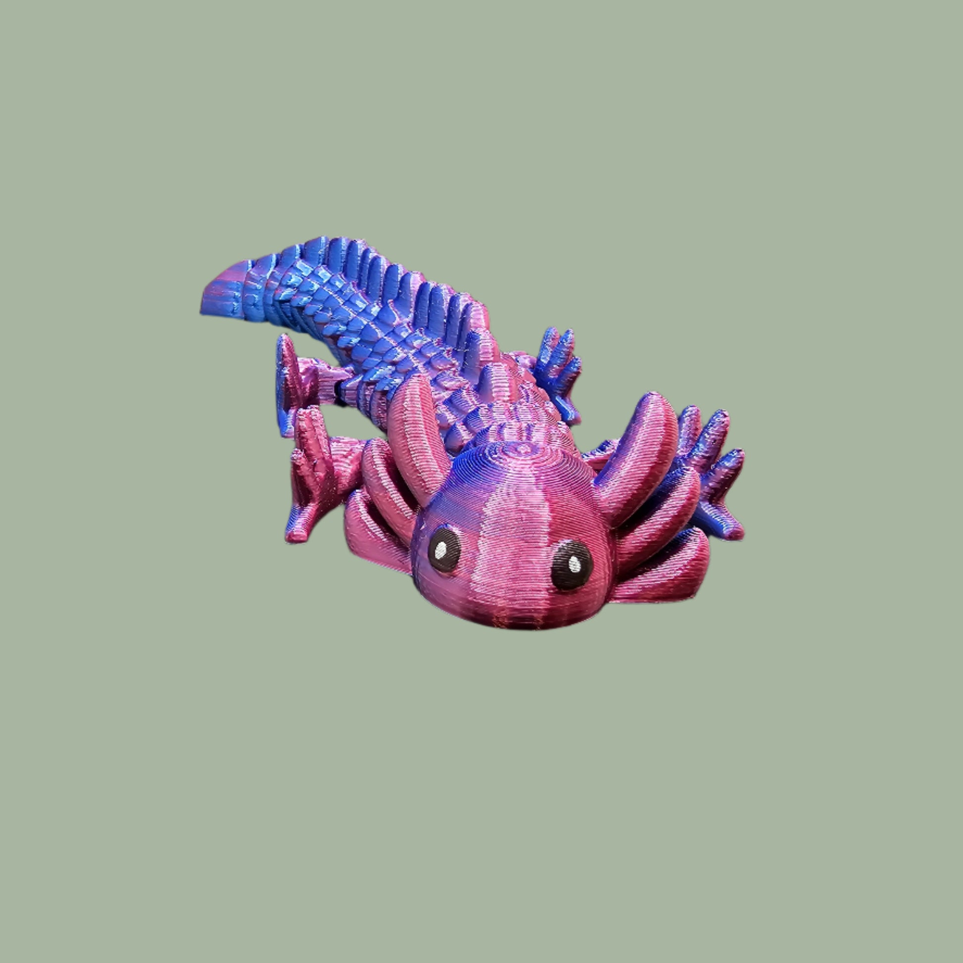 3D-printed articulated axolotl figurine in a shiny, colour-shifting finish. Handmade in the UK, approx. 21cm long, with a flexible, wiggly body. Perfect for axolotl lovers and fidget toy fans