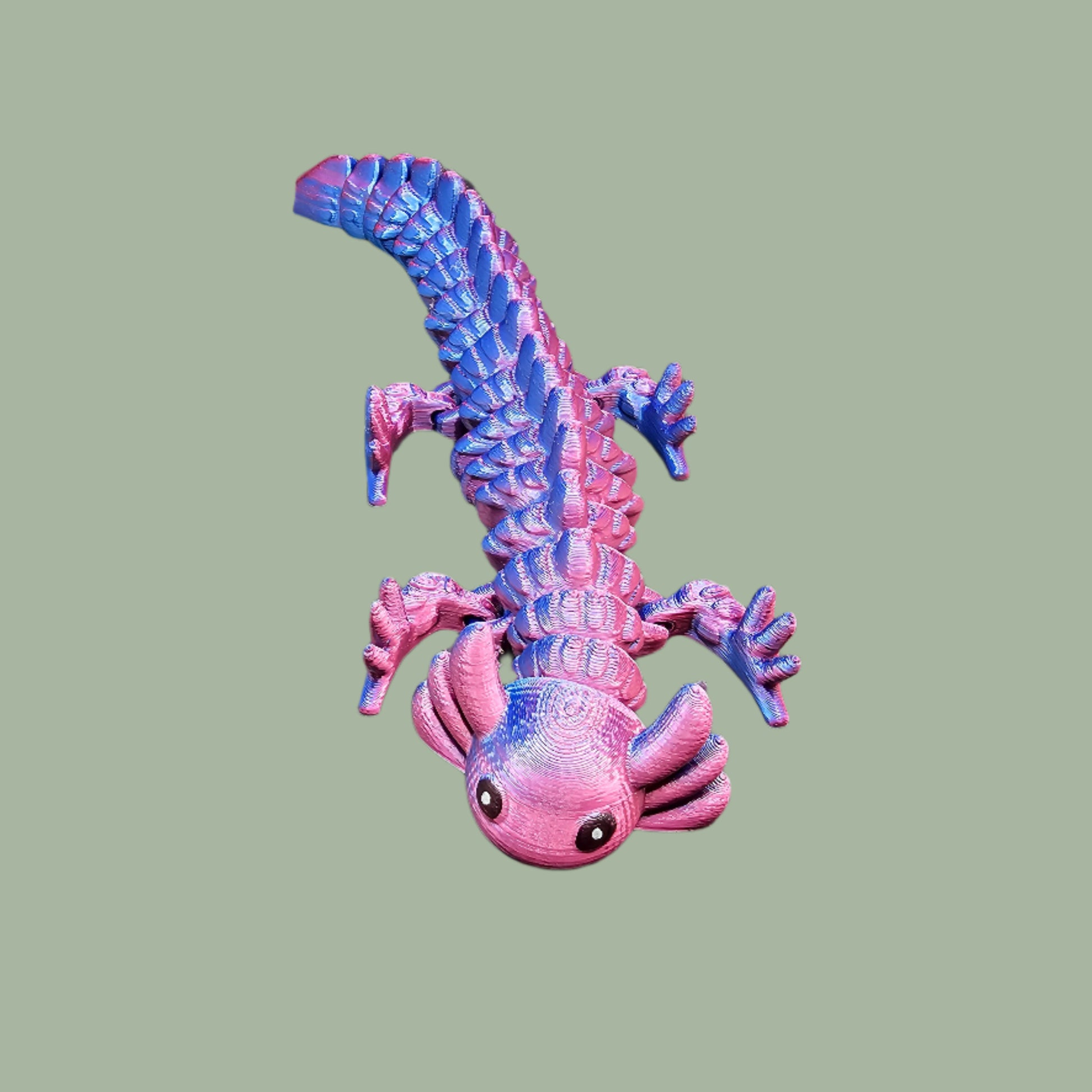 3D-printed articulated axolotl figurine in a shiny, colour-shifting finish. Handmade in the UK, approx. 21cm long, with a flexible, wiggly body. Perfect for axolotl lovers and fidget toy fans