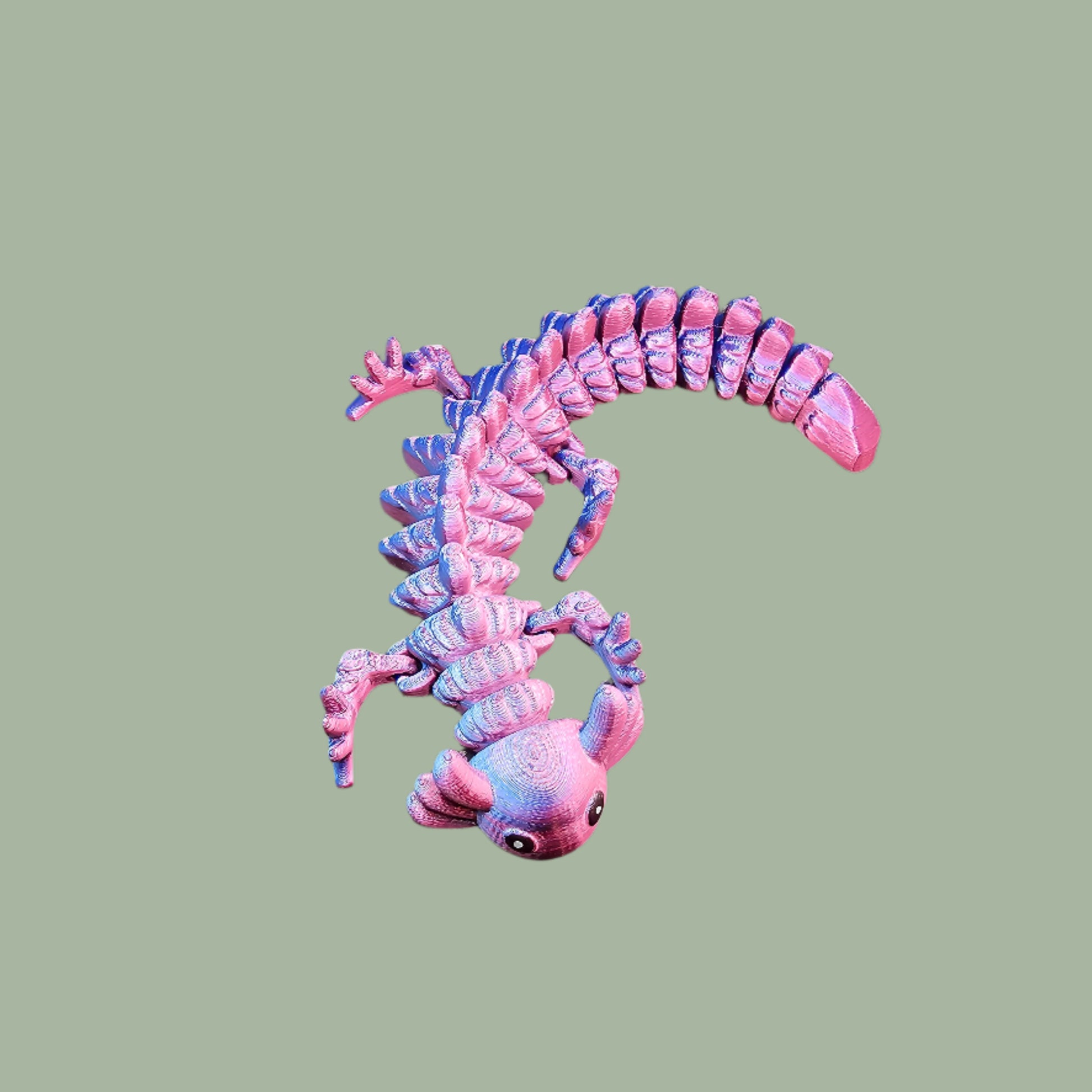 3D-printed articulated axolotl figurine in a shiny, colour-shifting finish. Handmade in the UK, approx. 21cm long, with a flexible, wiggly body. Perfect for axolotl lovers and fidget toy fans