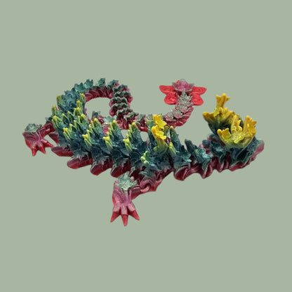 3D printed articulated dragon with cherry blossom details along the body and a flexi flower on the tail