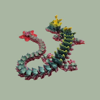 3D printed articulated dragon with cherry blossom details along the body and a flexi flower on the tail