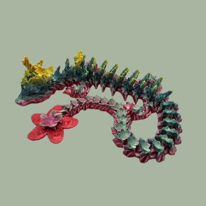 3D printed articulated dragon with cherry blossom details along the body and a flexi flower on the tail