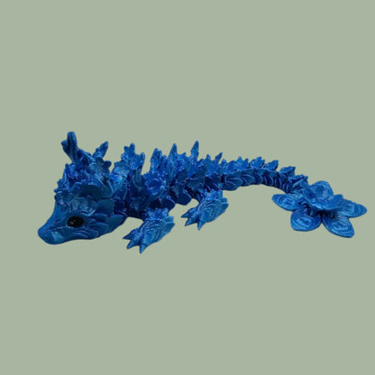 3D printed articulated dragon with cherry blossom details along the body and a flexi flower on the tail