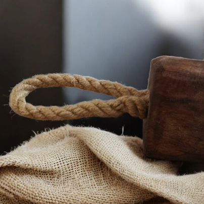 Solid wood doorstop with rustic rope handle