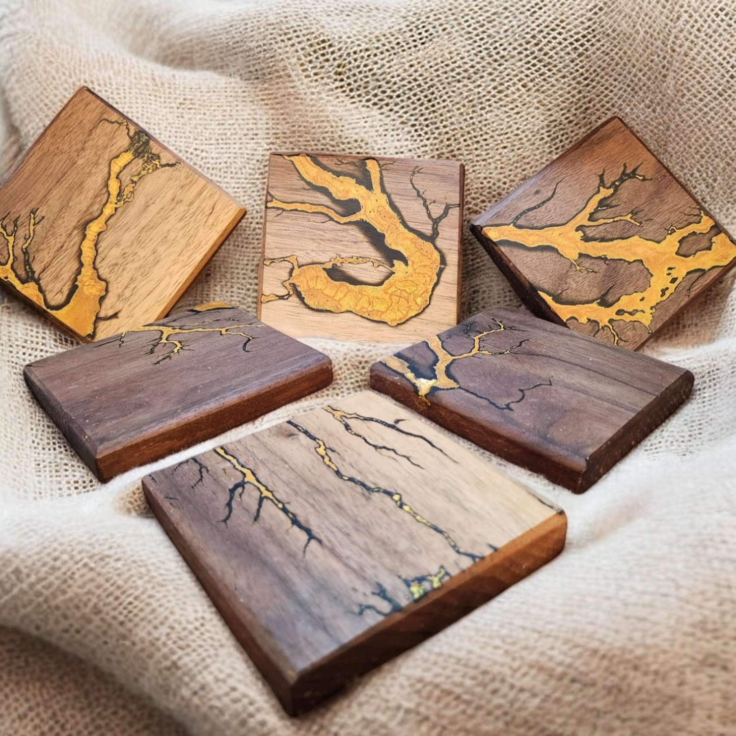 Solid wood coasters with electrocuted detail infilled in resin in a choice of colours