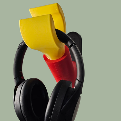 3D printed block style arm in various colours, with black base for wall or freestanding mounting, with chunky yellow hand to hold headphones or coats