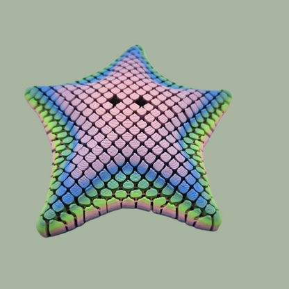 3D printed mesh articulated starfish with black eyes in a pastel rainbow colour