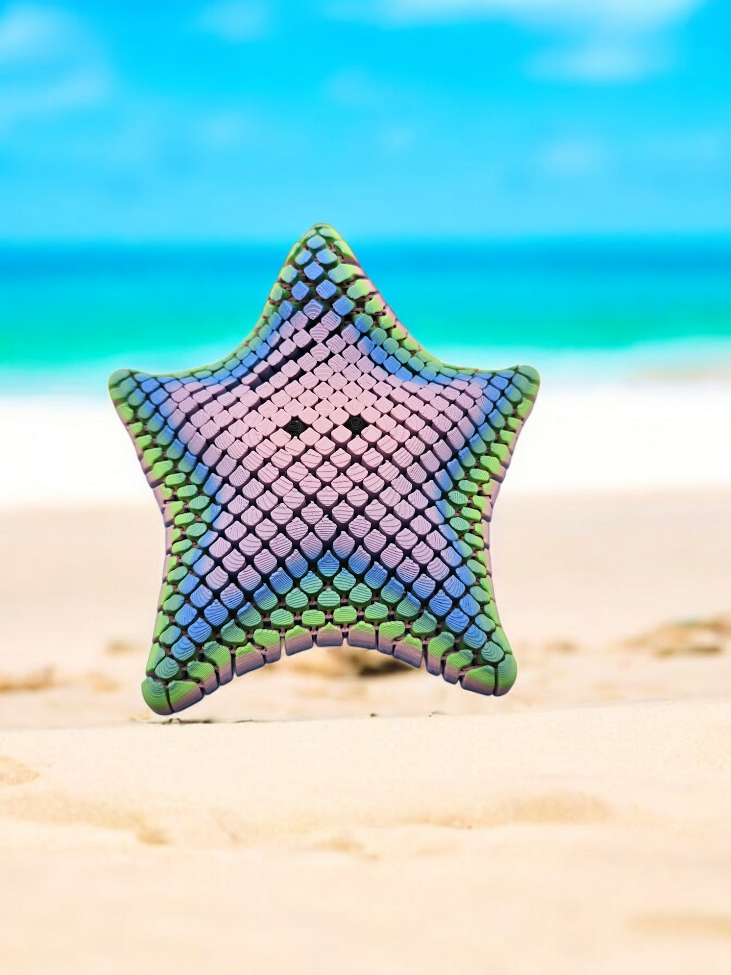 3D printed mesh articulated starfish with black eyes in a pastel rainbow colour