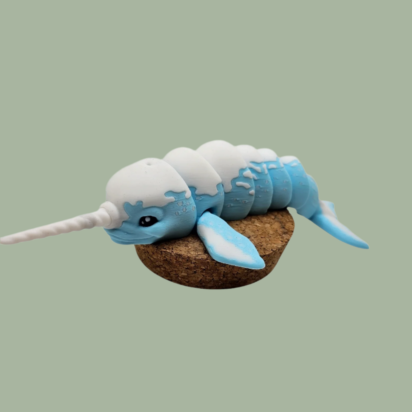 3D printed blue and white narwhal articulated desk buddy