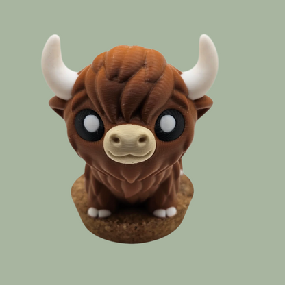 3D printed brown, white, and black Highland cow articulated desk buddy