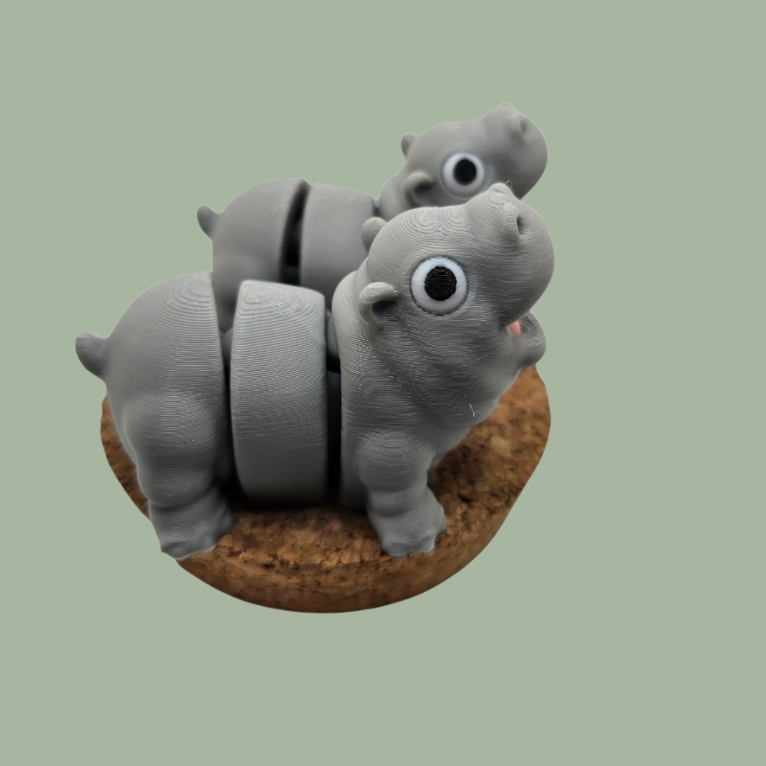 Pair of 3D printed happy flexi baby hippos, one with a pink throat/neck