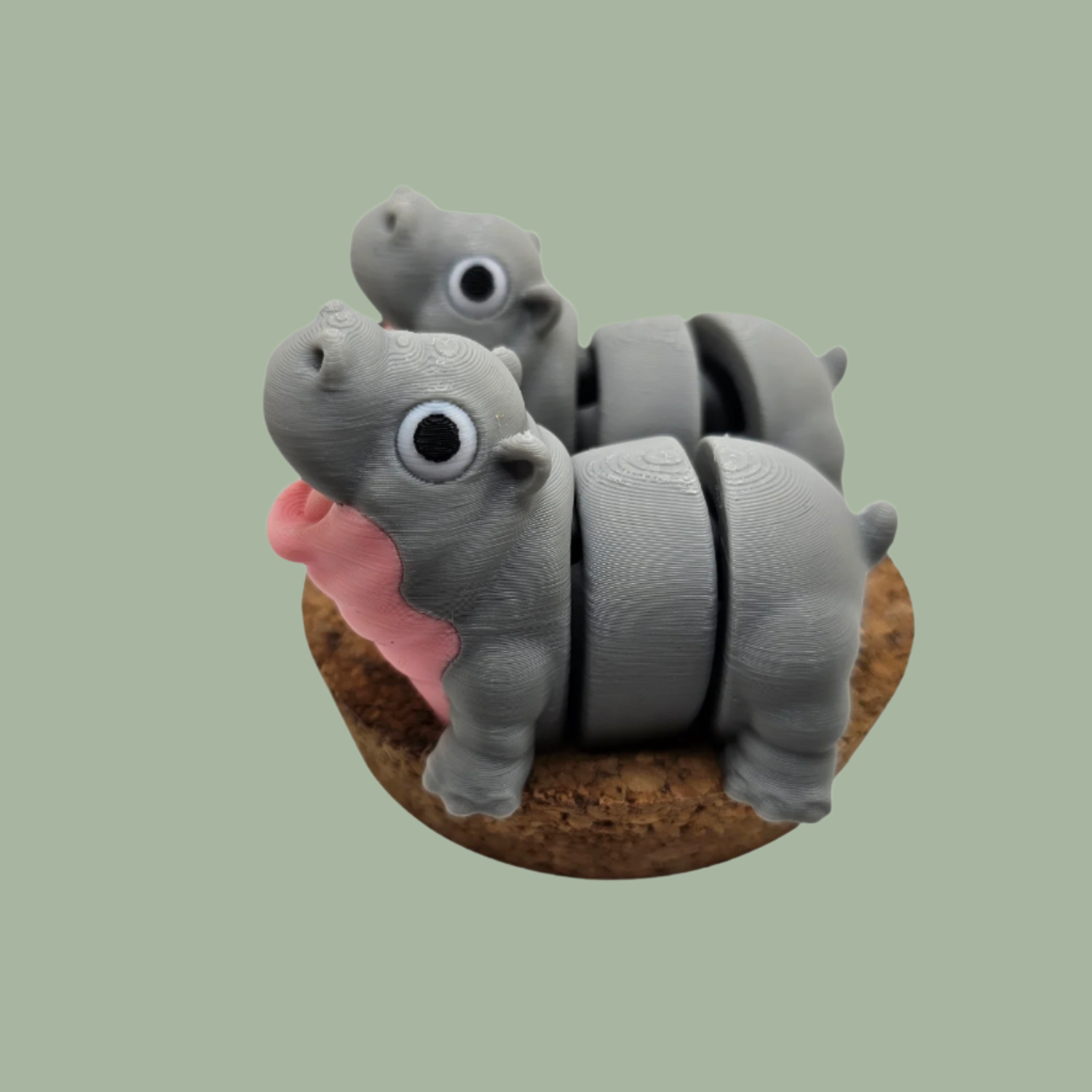 Pair of 3D printed happy flexi baby hippos, one with a pink throat/neck