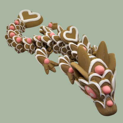 3D printed cookie style articulated dragon with pink and white icing details