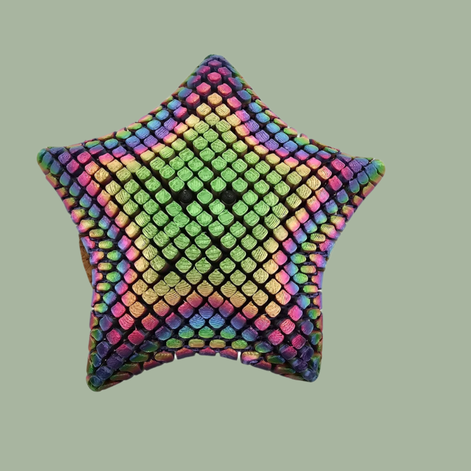 3D printed mesh articulated starfish with black eyes in a candy rainbow colour