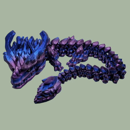 3D printed articulated dragon with large horns, in a purple/pink/blue colour