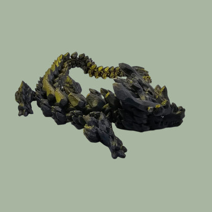 3D printed articulated dragon with large horns, in a green/black colour