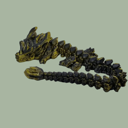 3D printed articulated dragon with large horns, in a green/black colour